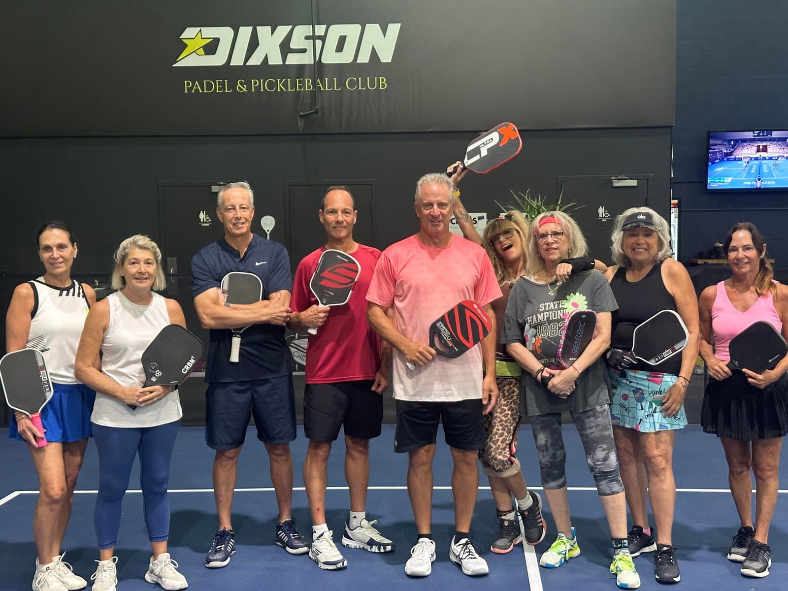 Texas pickleball players on court with their paddles