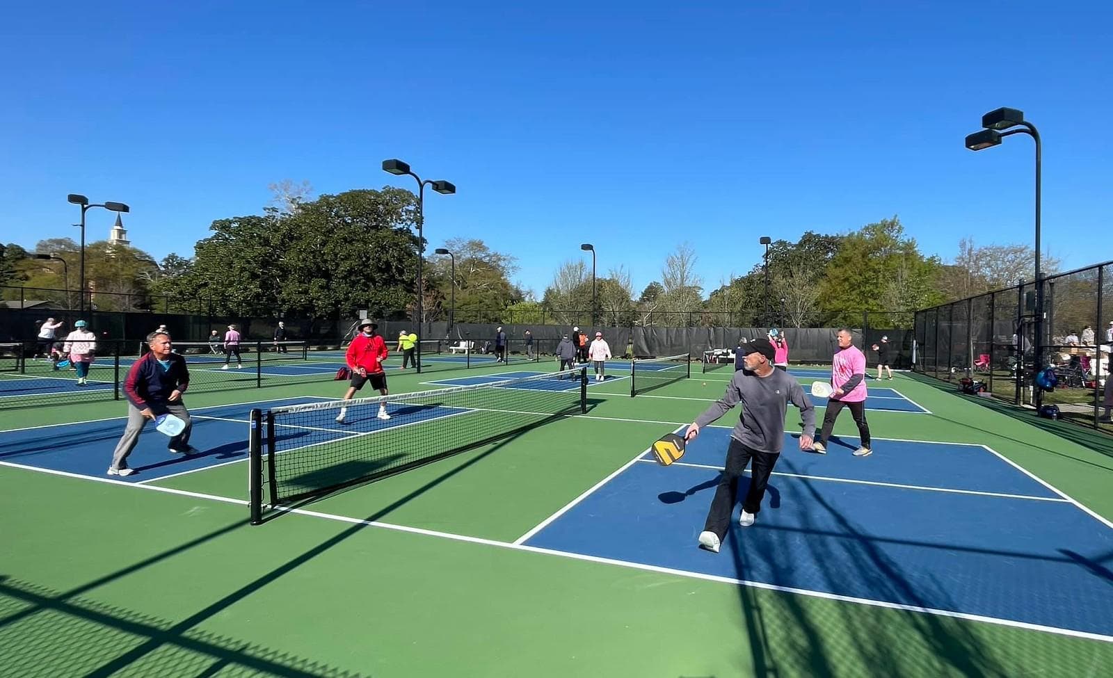 Outdoor pickleball courts mid-game